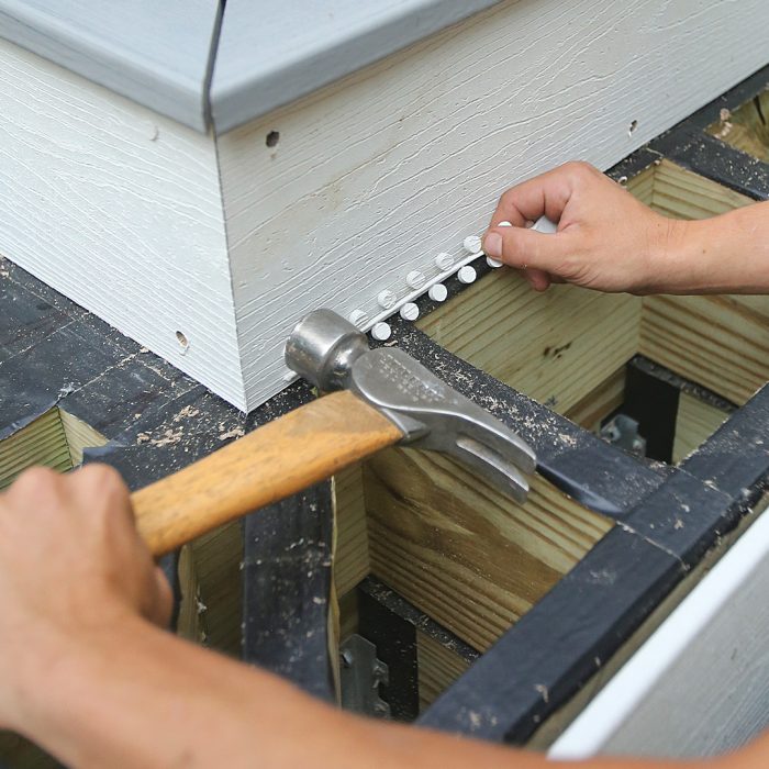 Man uses hammer to plug screw holes before they are partially covered by the stair tread.
