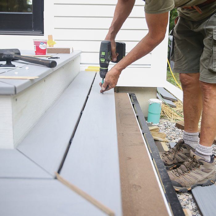 Man installs solid edge boards using fasteners.
