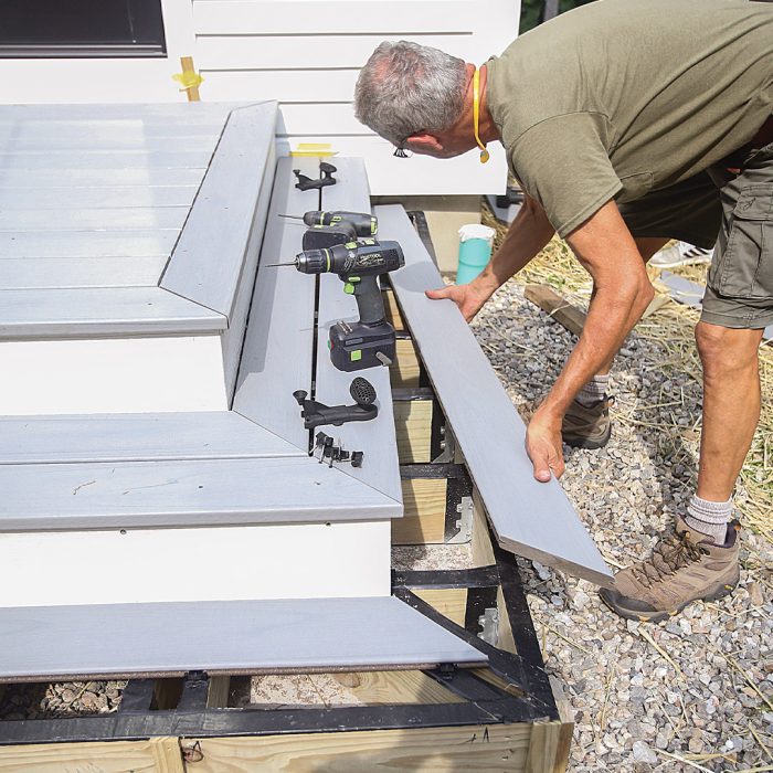 Man installs tread boards secured by hidden starter clips.