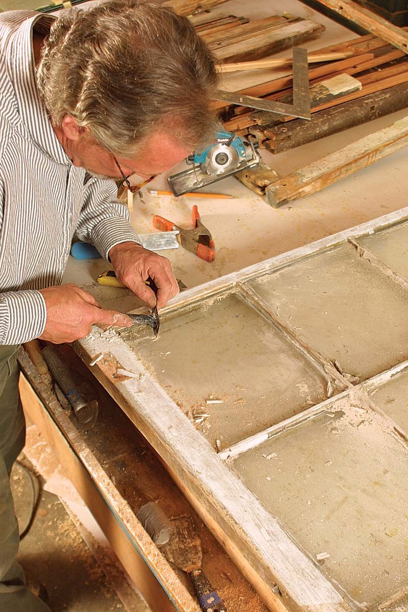 scraper along the surface of the glass to remove the old glazier’s points.