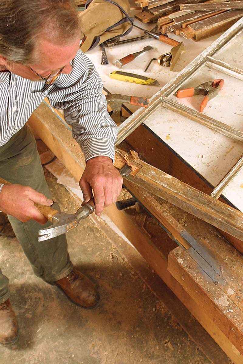 Deep gouges and rot are carved out and squared up with a chisel to make room
