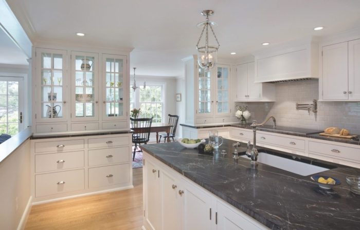 The kitchen, dining room, and family room are not quite open plan, owing to columns and room-dividing cabinets that define separate spaces, in keeping with an old house. Sight lines are unimpeded.